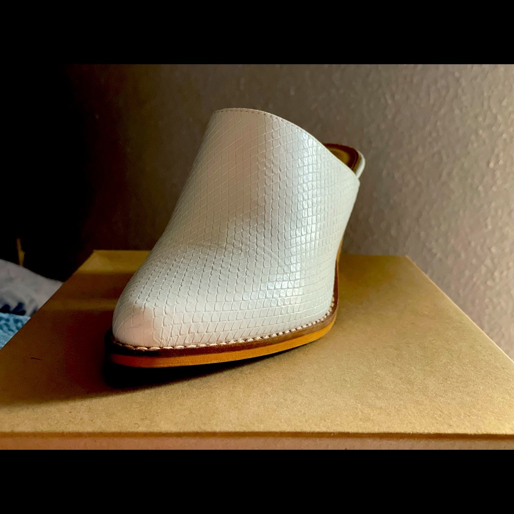 White textured block heel mule.